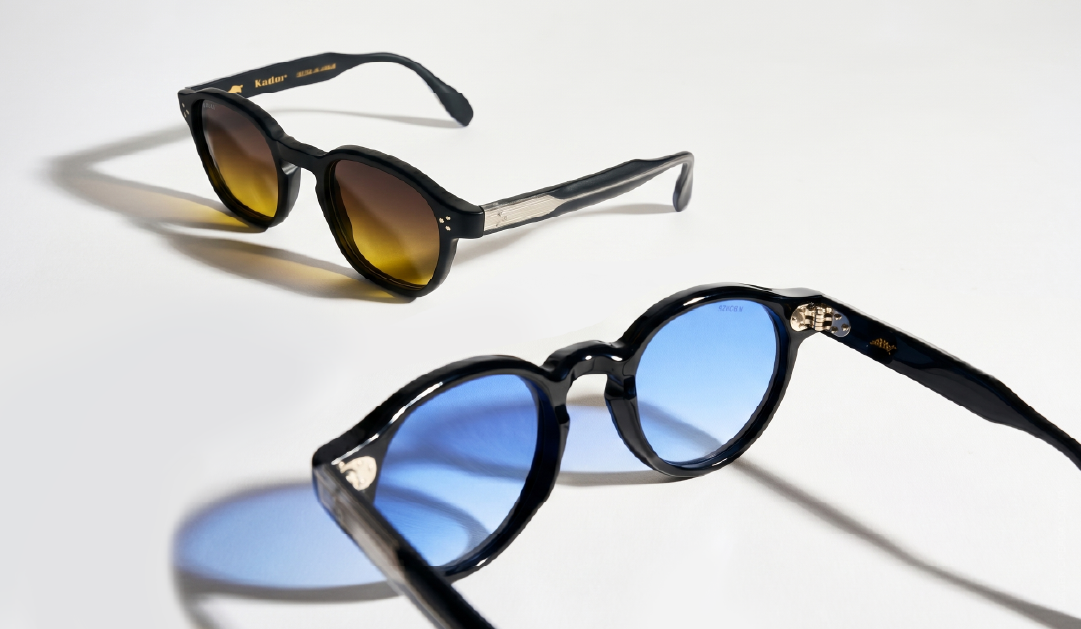 Two sunglasses on a white surface: one with brown gradient lenses, the other with blue mirrored lenses.
