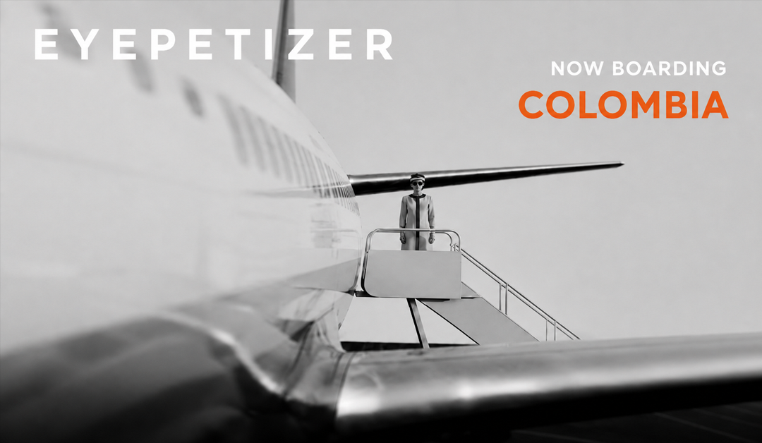 Brand ad: airplane boarding stairs with a person in suit; text reads 'EYEPETIZER' and 'NOW BOARDING COLOMBIA' in white and orange.